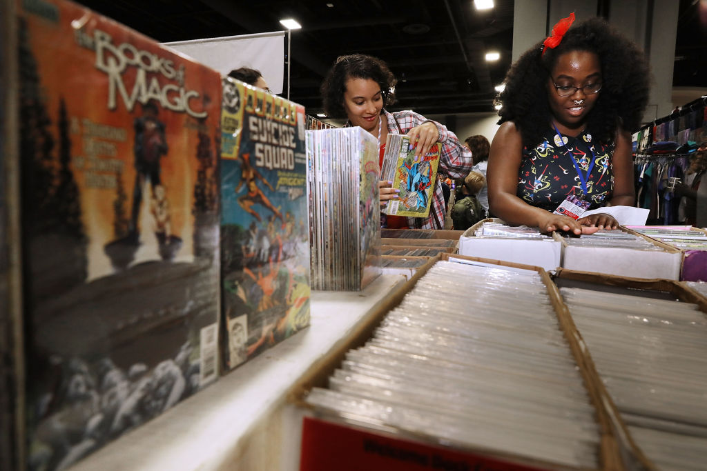 Caitlin Laurent (L) of Rockville, MD, and Lauren McNeal of Silver Spring, MD, shop for comic books during the first day of Awesome Con at the Walter E. Washington Convention Center June 16, 2017 in Washington, DC. Thousands of fans of popular culture, fantasy and science fiction will gather for the three-day convention that includes comic books, collectibles, toys, games, original art, cosplay and Marvel Comics legend Stan Lee. (Photo by Chip Somodevilla/Getty Images)