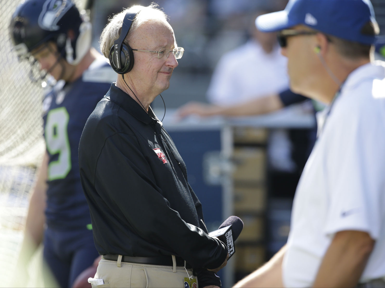 John "The Professor" Clayton, an NFL football writer and reporter was one of the 100 on-air talent laid off by ESPN in April 2017. In this file photo he stands on the sideline during an NFL football game between the Seattle Seahawks and the San Francisco 49ers, Sunday, Sept. 25, 2016, in Seattle. (AP Photo/Ted S. Warren)