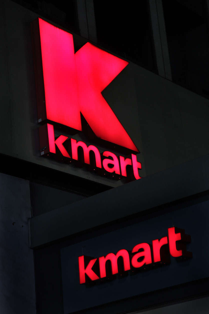 FILE - This Nov. 9, 2011 file photo, shows signs at a Kmart store, in New York. Kmart, a division of Sears Holdings Corp., said Friday, Sept. 7, 2012, that it's waiving the fees that shoppers pay to open its interest-free pay-over-time program at its discount stores and online through  Nov. 17. (AP Photo/Mark Lennihan, File)