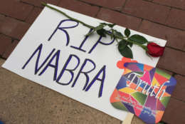 photo shows a sign that says RIP Nabra with a rose