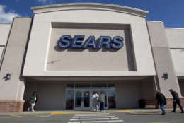 In this Feb. 22, 2012 photo, shoppers enter a Sears department store location in Dedham, Mass.  Sears Holdings said Thursday, Feb. 23, 2012, it will separate its smaller hometown stores, outlets and some hardware stores in a deal expected to raise $400 million to $500 million as it seeks to regain profitability and market share. (AP Photo/Steven Senne)