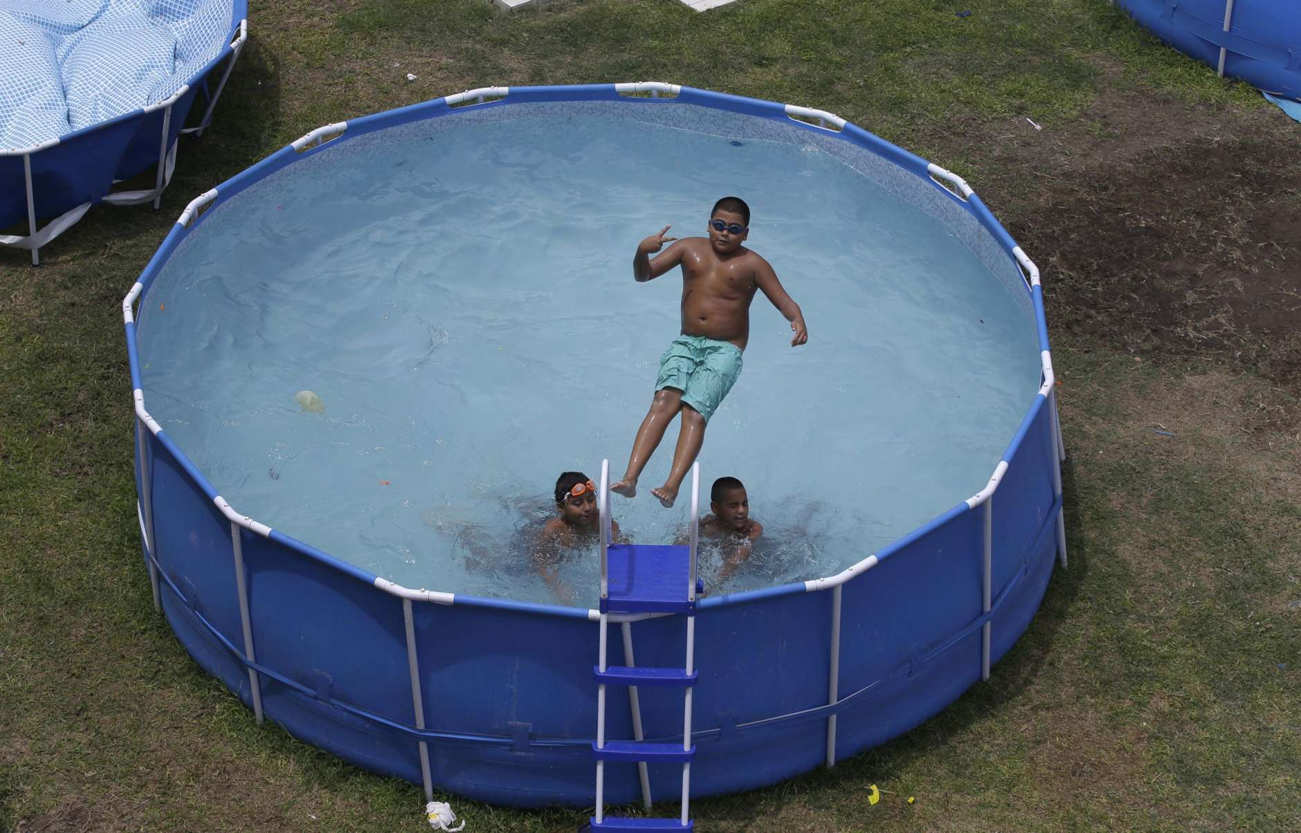 Above-ground pools are an alternative to more costly in-ground pools, but don't necessarily add value to a home. (AP Photo/Martin Mejia)