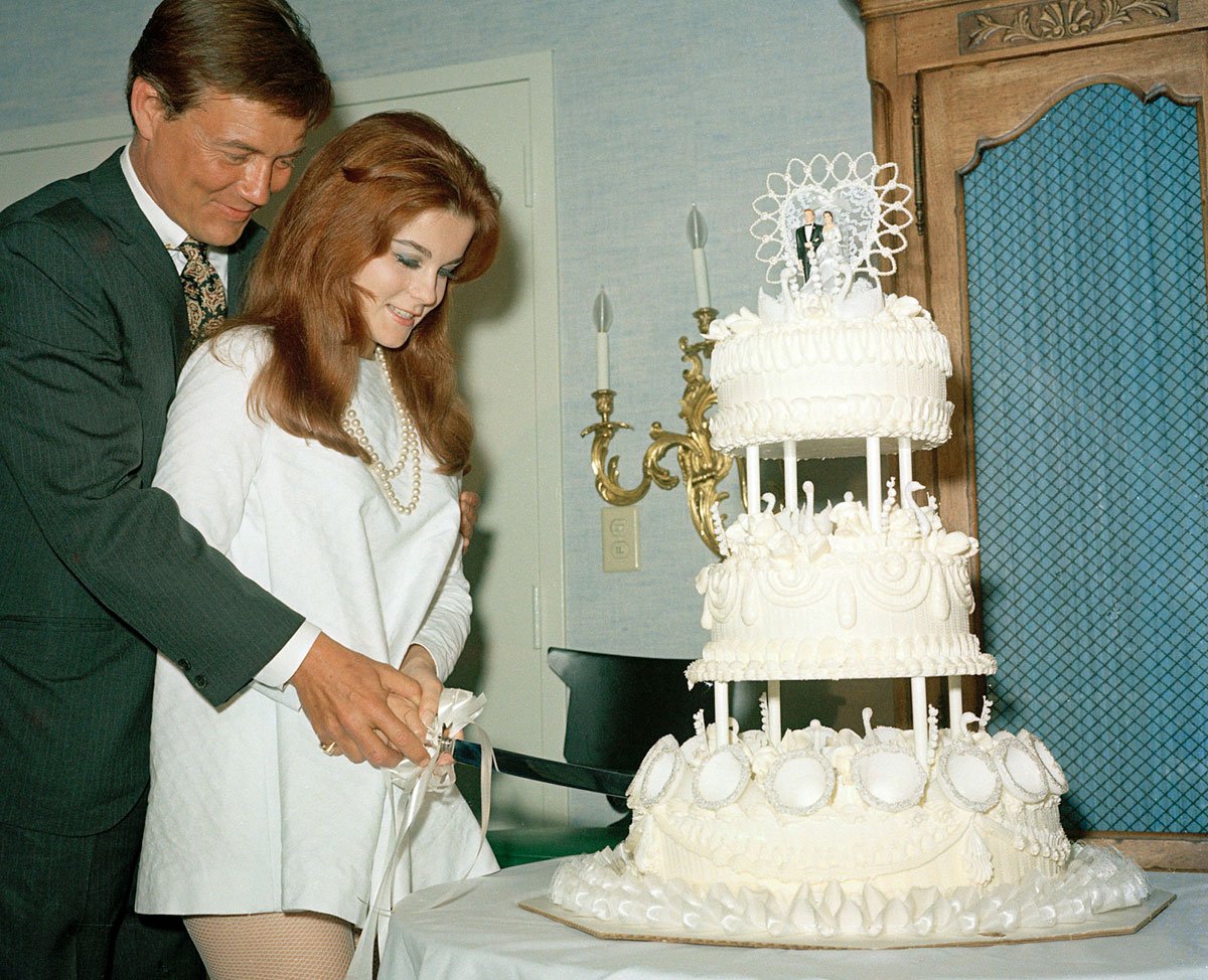 Actors Ann-Margret and Roger Smith are shown cutting the cake on their wedding day, May 8, 1967, in Las Vegas. (AP Photo)