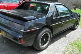 A witness reported seeing a black Pontiac Fiero like this one in the store parking lot about the time of the murder. (Courtesy Montgomery County Police Department)