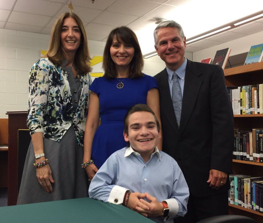 Clockwise from left, Del. Eileen Filler-Corn, Sylvia, Steve and Brandon Farbstein, attend the signing of two new laws on June 6, 2017 in Woodbridge that deal with mental health and bullying in school. (WTOP/Kristi King)
