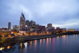Nashville Skyline at sunset with reflections in river.  An Autumn afternoon with a colorful blue sky at twilight and the city lights all lit up. (Thinkstock)