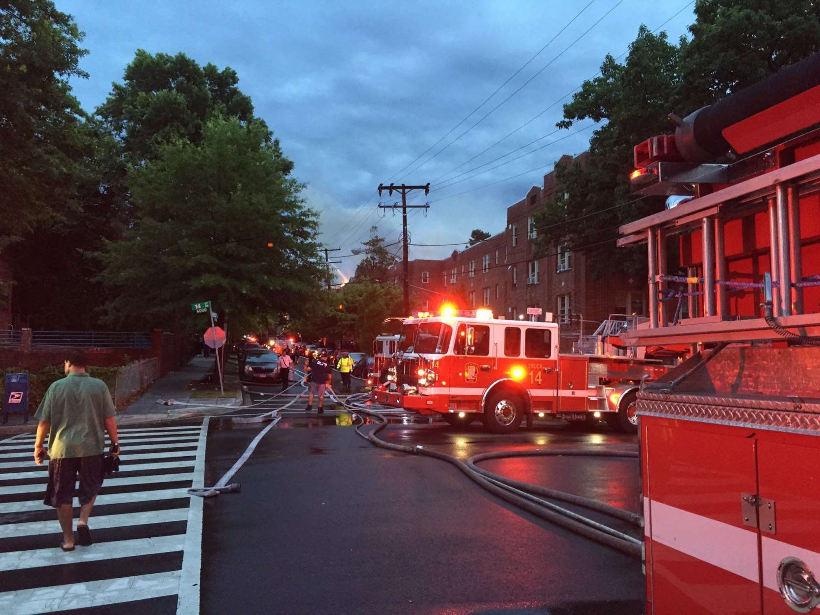 Responders continue to battle the overnight Northwest fire Saturday morning. (WTOP/Dennis Foley)