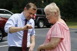 Democratic candidate for governor, former congressman, Tom Perriello, left, talks with Gretchen Craig of Chesterfield, outside a polling place Tuesday, June 13, 2017, in North Chesterfield, Va. Perriello faces Lt. Gov Ralph Northam faces in today's primary. (AP Photo/Steve Helber)
