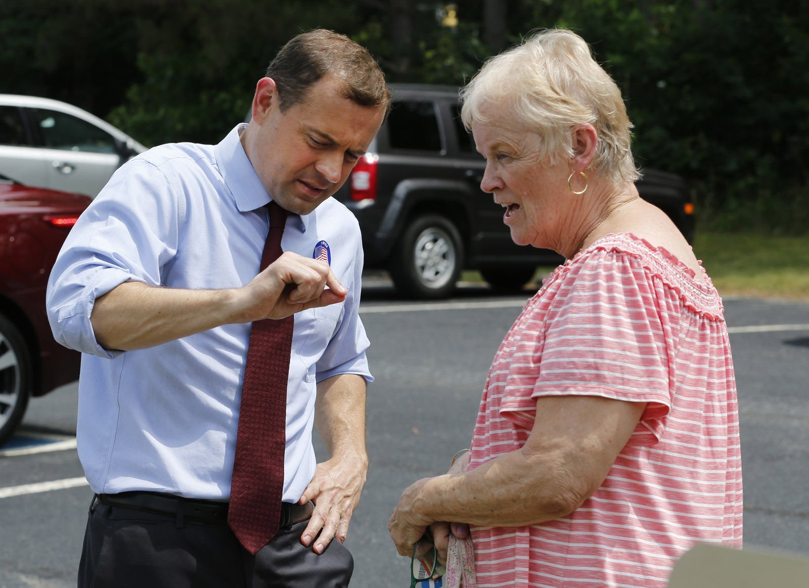 Democratic candidate for governor, former congressman, Tom Perriello, left, talks with Gretchen Craig of Chesterfield, outside a polling place Tuesday, June 13, 2017, in North Chesterfield, Va. Perriello faces Lt. Gov Ralph Northam faces in today's primary. (AP Photo/Steve Helber)