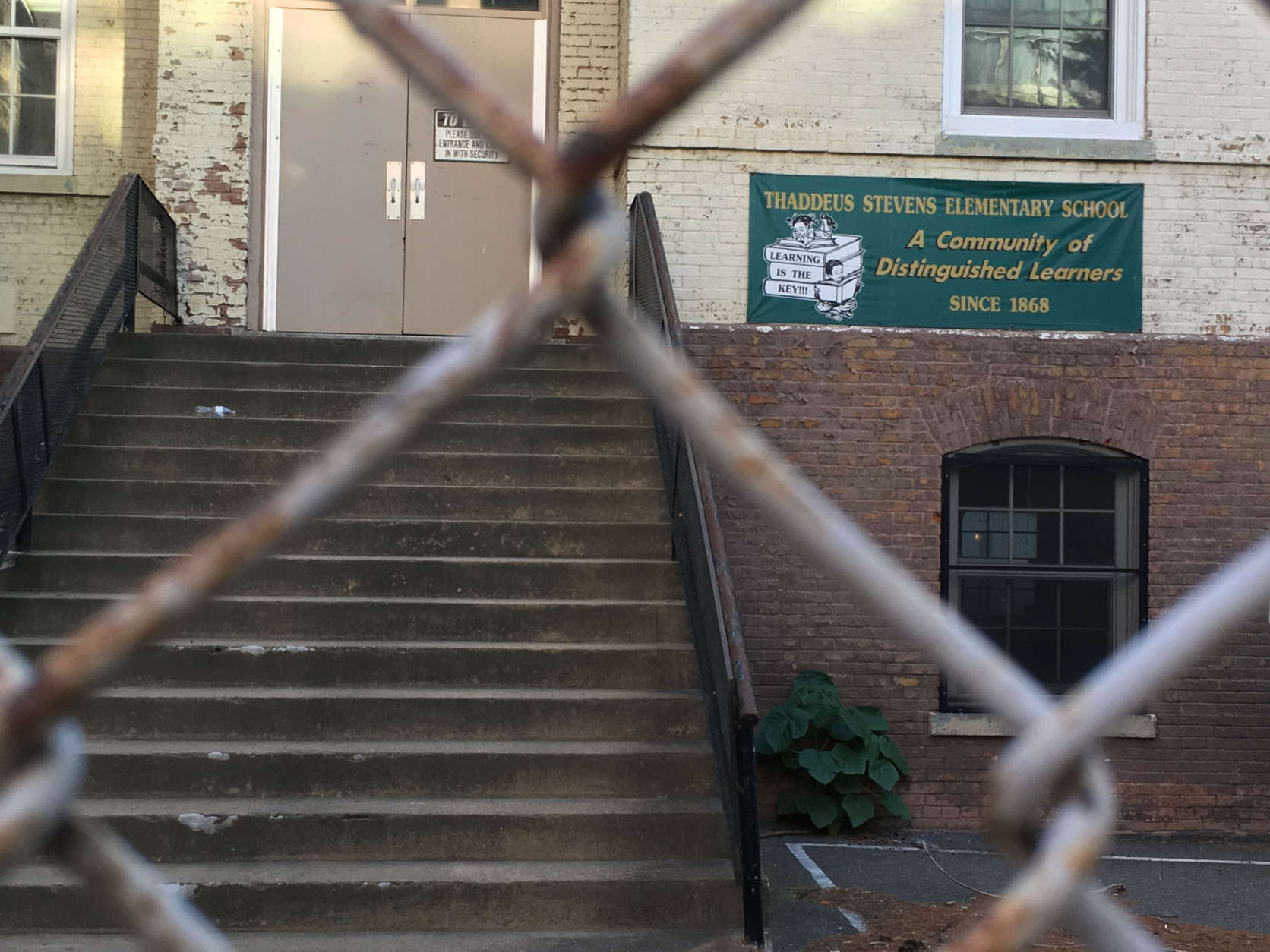 Stevens Elementary is now tucked away by a chain-link fence, looking somewhat out of place amid downtown D.C. office buildings. (WTOP/Jack Moore)
