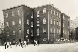 An undated photograph shows Thaddeus Stevens Elementary School. The photograph was probably taken in the 1950s or 1960s based on the fashions worn by the students. The school served as the anchor of the at-the-time predominantly African-American communitye called the West End. During World War II, the school principal was put in charge of handing out ration stamps, and the school even donated the bell from the loft for scrap metal. "To generations of black families here, (the school) was an object of pride, a symbol of high aspirations,” the New York Times reported. (Courtesy Charles Sumner School Museum and Archives)