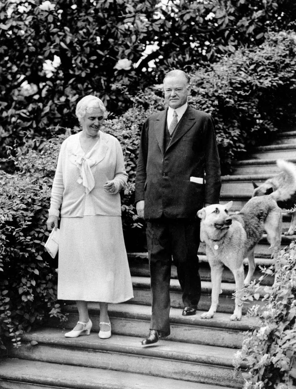 U.S. President Herbert Hoover, right, is shown with first lady Lou Henry Hoover and their dogs in Washington, D.C., on June 15, 1932, in the final year of his presidential term.  (AP Photo)
