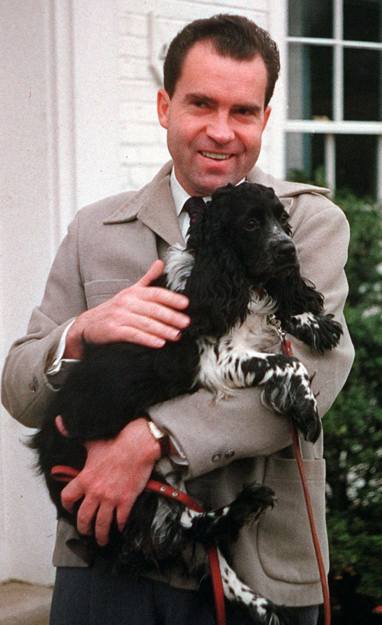 FILE-- Richard Nixon is seen with his dog "Checkers," at his home in Spring Valley neighborhood of Washington, DC., in this July 2, 1959 file photo. Not even a president should be separated from his faithful dog, especially if the canine helped save his political career. The body of Richard Nixon's cocker spaniel, Checkers, may be exhumed from a New York cemetery and reburied near the former president and his wife Pat in California. (AP Photo/ FILE)