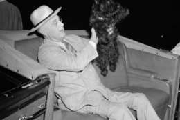President Franklin D. Roosevelt lifts his dog Fala as he prepares to motor from his special train to the Yacht Potomac at New London, Conn., Aug. 3, 1941.  The president began a vacation voyage scheduled for a week or 10 days. (AP Photo)