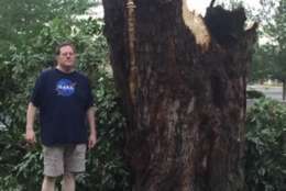 A Queen Anne's County resident stands next to a broken tree after Monday's storm. (Courtesy Angie Chambers Russe)