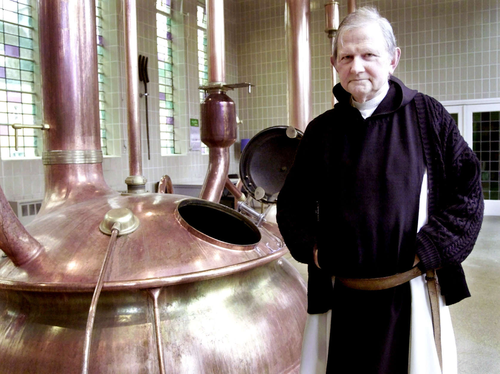 Father Abt of the Notre Dame de Saint Remy, poses at the brewery room in Rochefort, 60 miles south of Brussels, Jan. 24, 2002. The abbey is one of only a half a dozen monasteries where the monks still follow the centuries old Trappist tradition of beer making and its strong, dusky brews are hailed by connoisseurs as some of the world's best. (AP Photo/Yves Logghe)