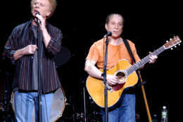Paul Simon, right, and Art Garfunkel perform at the Fleet Center in Boston, Thursday, Dec. 11, 2003. (AP Photo/Robert E. Klein)