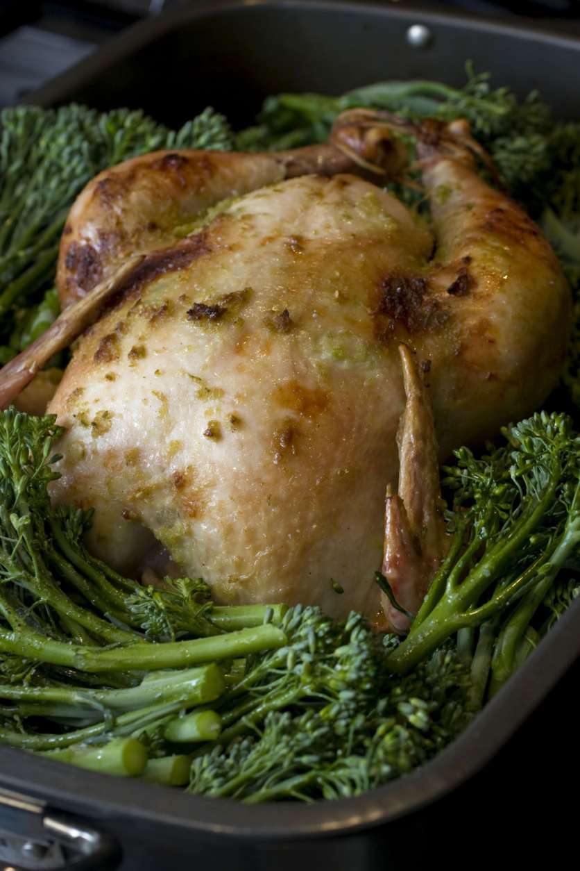 This photo taken Aug. 30, 2009 shows a  Jalapeno Roast Chicken with Baby Broccol.  Marcela Valladolid's recent cookbook "Fresh Mexico" features modern Mexican cuisine using less of the common ingredients Americans are use to and looking to fresh vegetables, an expanded selection of chilies and even oysters, crabs and prunes. Fresh broccolini is arranged around the whole chicken for the final roasting of Jalapeno Roast Chicken with Baby Broccoli. (AP Photo/Larry Crowe)