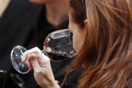 A woman tastes a glass of Tuscan red wine on the opening day of the 44th edition of the annual International Wine and Spirits Exhibition "Vinitaly", in Verona, northern Italy, Thursday, April 8, 2010. The wine exhibition runs until April 12. (AP Photo/Luca Bruno)