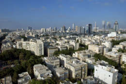 FILE - In this Thursday, June 3, 2004 file photo, a view of downtown Tel Aviv and its skyline, with Israel's Defense Ministry, seen in the background, fourth tower from the top right. Despite its confident saber-rattling, there are growing concerns in Israel that the country may be catastrophically vulnerable to counterstrike if it attacks Iran's nuclear program. A rocket-defense system is being thrown up in Tel Aviv, where Israel's sprawling military headquarters sits smack in the middle of office towers, art museums, nightlife districts and tourist hotels. (AP Photo/Ariel Schalit, File)