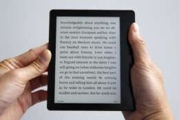 A model holds Amazon's Kindle Oasis, Thursday, April 28, 2016, in New York. The Oasis is meant to be a luxury e-book reader, and is the company's sleekest, lightest e-book reader yet. It's designed strictly for reading, without Facebook, streaming video and other distractions common on full-functioning tablets. (AP Photo/Kathy Willens)