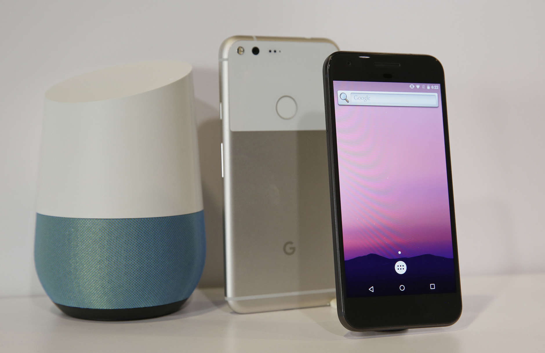 FILE - In this Oct. 4, 2016 file photo, the new Google Pixel phone is displayed next to a Google Home smart speaker, left, following a product event in San Francisco. Google’s new smart speaker is at once a secretary, a librarian and a radio. If all this sounds familiar, it’s because Amazon has been at it for about two years. Its Echo speaker can do what Home does and more, thanks to Amazon’s head start in partnering with third-party services such as Domino’s Pizza and Fitbit. But Home is smarter in a few other ways, as it taps what it knows about you from Gmail, Maps and other Google services.  (AP Photo/Eric Risberg)