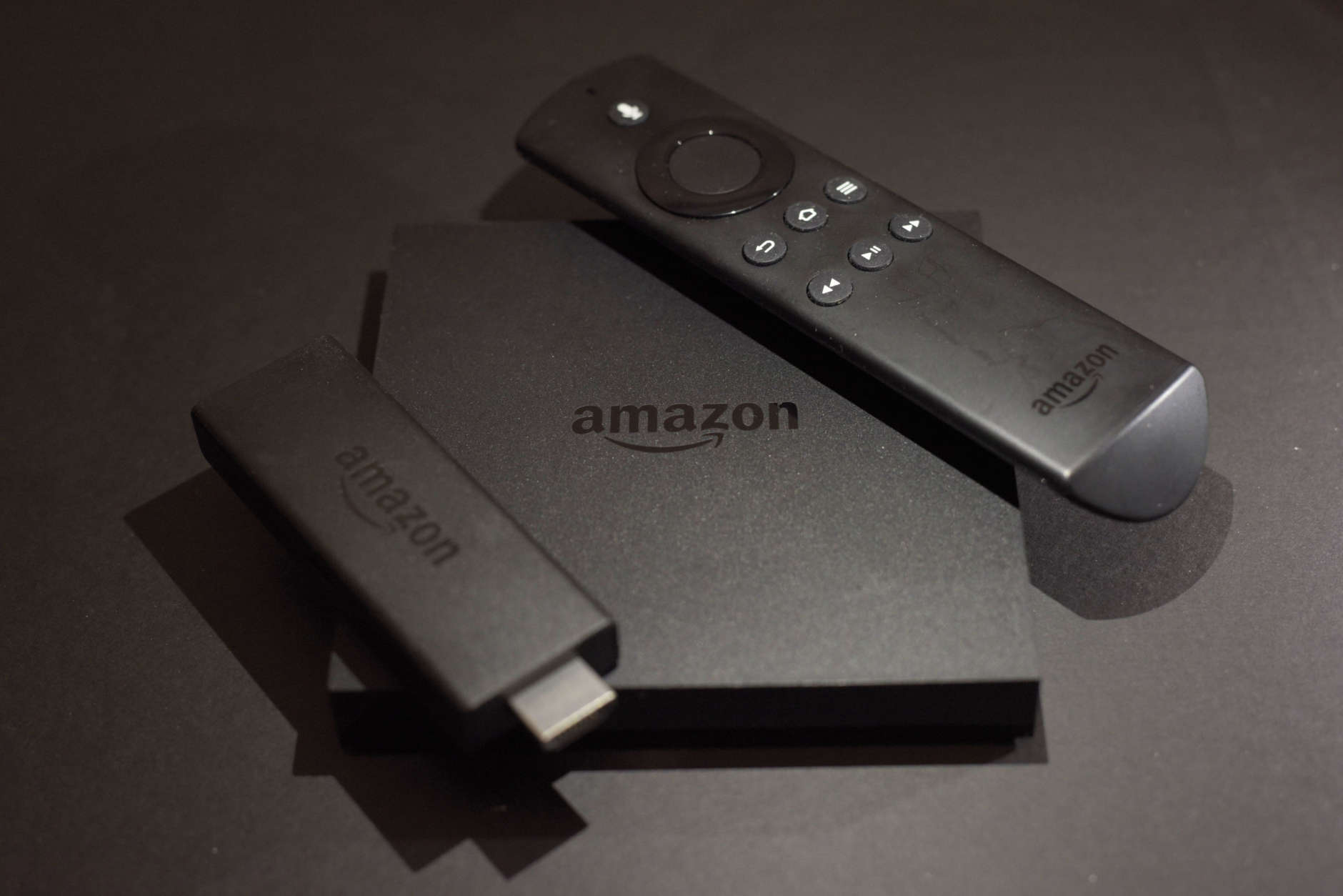 This Wednesday, Nov. 16, 2016 photo shows the Amazon Fire TV, center, and Fire TV Stick, left, streaming TV devices in New York. Your streaming TV options just got better and cheaper. Features that once required a $100 device can now be had for as little as $30. A cheap device is fine for getting TV shows and movies from most popular services onto a big-screen TV, as long as it’s a regular, high-definition set.(AP Photo)