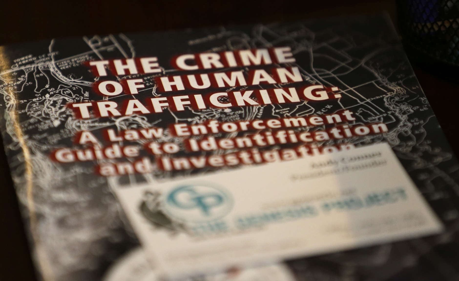 In this photo taken Feb. 27, 2017, a law-enforcement guide to human trafficking sits on a table at The Genesis Project, a drop-in center for victims of sex trafficking in SeaTac, Wash. A measure passed last week in the Washington state Senate could rewrite current law to make it easier for victims of trafficking to vacate prostitution convictions. (AP Photo/Ted S. Warren)
