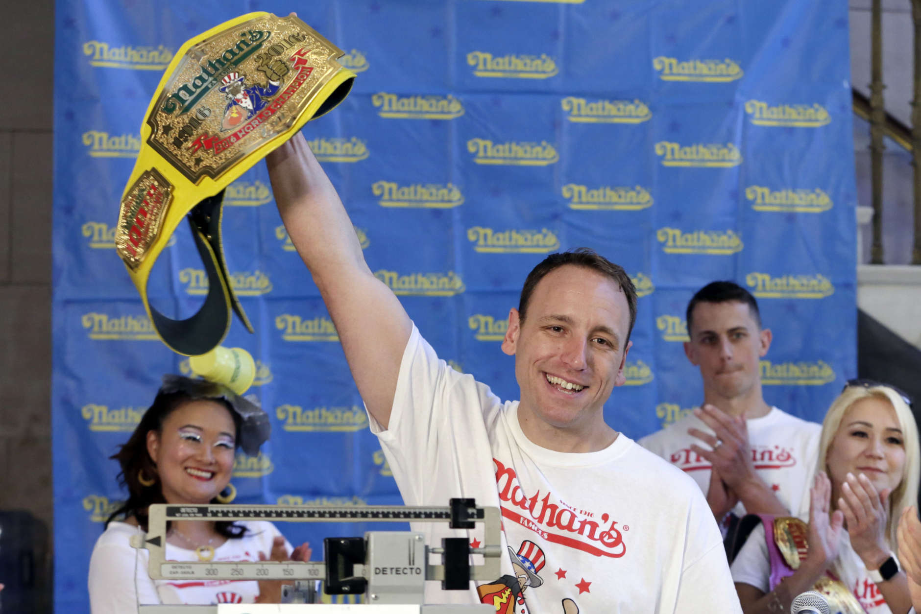 Eight-time men's champion Joey Chestnut, of San Jose, Calif., holds holds his championship belt during the weigh-in for the 2017 Nathan's Hot Dog Eating Contest, in Brooklyn Borough Hall, in New York, Monday, July 3, 2017. Chestnut weighed-in at 221.5 pounds. The current women's champ, Miki Sudo, of Las Vegas, is at right. (AP Photo/Richard Drew)