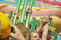 Miki Sudo, center, celebrates after winning the women's division of the Nathan's Famous Hot Dog Eating Contest on Tuesday, July 4, 2017, in the Brooklyn borough of New York. The Las Vegas woman ate 41 hot dogs and buns in 10 minutes to win her fourth straight title. (AP Photo/Bebeto Matthews)