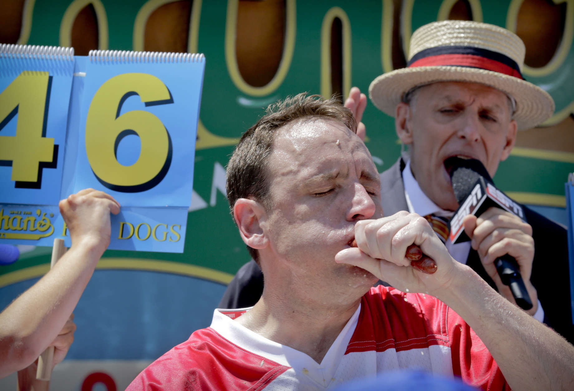 Joey Chestnut eats two hot dogs at a time during the Nathan's Annual Famous International Hot Dog Eating Contest, Tuesday July 4, 2017, in New York. Chestnut won, marking his 10th victory in the event. (AP Photo/Bebeto Matthews)