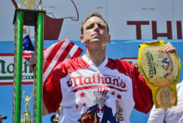 Joey Chestnut holds his trophies after winning Nathan's Annual Famous International Hot Dog Eating Contest, marking his 10th victory in the event, Tuesday July 4, 2017, in New York. (AP Photo/Bebeto Matthews)