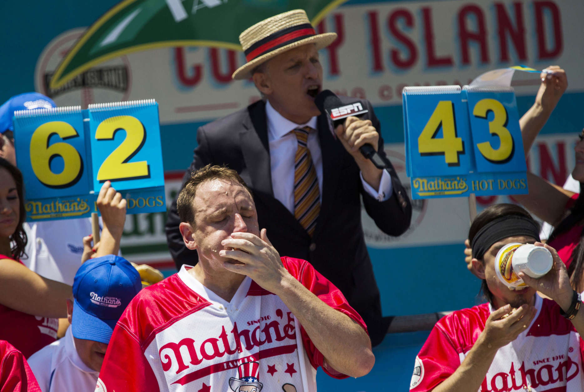 Joey Chestnut, left, and Matt Stonie compete in the Nathan's Famous Hotdog eating contest Tuesday, July 4, 2017, in Brooklyn, New York. Chestnut ate 72 hotdogs in 10 minutes to claim his 10th win. (AP Photo/Michael Noble Jr.)