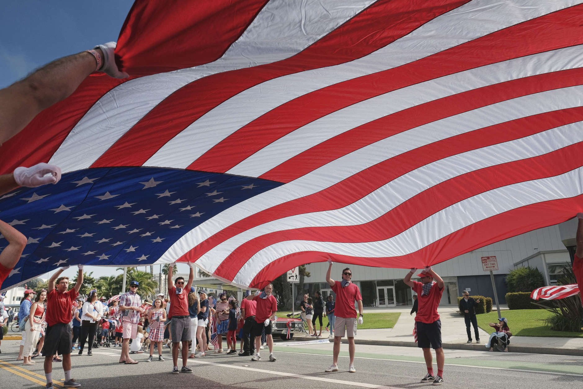 Participants carry an American flag during the 4th of July parade in Santa Monica, Calif. on Tuesday, July 4, 2017. Decked out in red, white and blue, Californians waved flags and sang patriotic songs at Independence Day parades across the state. (AP Photo/Richard Vogel)