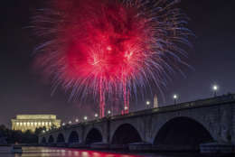 Fireworks burst over the Memorial Bridge during Independence Day celebrations on the National Mall in Washington, Tuesday, July 4, 2017. (AP Photo/J. David Ake)