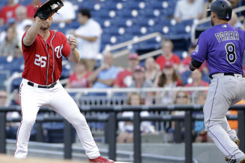 Lind, Goodwin homer in 5th, Nationals beat Rockies for split