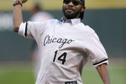 Actor Nelsan Ellis throws out a ceremonial first pitch before of a baseball game between the Chicago White Sox and the Baltimore Orioles Wednesday, Aug. 20, 2014, in Chicago. (AP Photo/Charles Rex Arbogast)