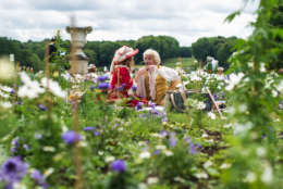 Visitors Fanny and Patrice wear costumes and lunch in the Vaux-Le-Vicomte castle during the "Journee Grand Siecle", the Great Century Day, in Maincy, outside Paris, France, Sunday June 21, 2015. The event aims at recreating King Louis XIV's 17th century atmosphere in the castle and its gardens. (AP Photo/Kamil Zihnioglu)