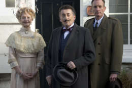 British actor Robert Powell, centre, dressed as the character Poirot, poses at a photo call for Agatha Christie's first ever play, Black Coffee. Alongside Powell are actors Liza Goddard, as Miss Caroline Amory, and Robin McCallum, right, as Poirots friend and confidante Captain Arthur Hastings. The photo call took place outside the former west London residence of author Christie, in Cresswell Place, London, Friday, Jan. 10, 2014. (Photo by Joel Ryan/Invision/AP)