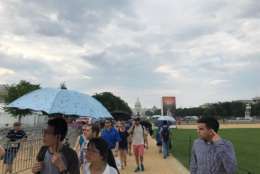The umbrellas were out along the National Mall Tuesday for the Smithsonian Folklife Festival. (WTOP/Dick Uliano)