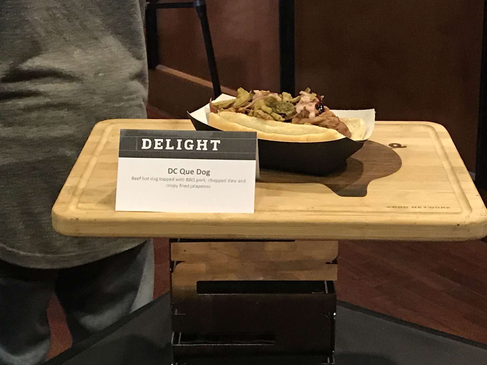 Another new food item is this DC Que Dog, which is a beef hotdog topped with BBQ pork, chopped slaw and crispy fried jalapenos. (WTOP/Ginger Whitaker)