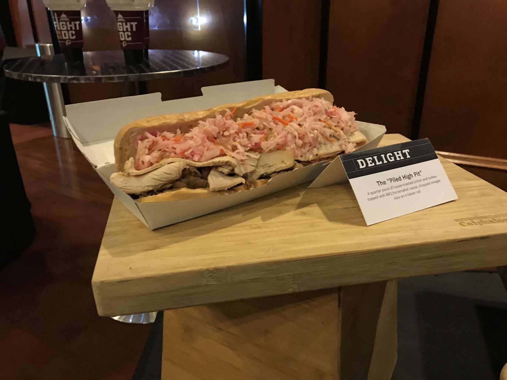 Feeling hungry at FedExField? Try the "Piled High Pit" from Skins Pit, which is more than a mouthful: a quarter pound of house-roasted sirloin and turkey topped with BBQ horseradish sauce, chopped vinegar slaw on a Kaiser roll. (WTOP/Ginger Whitaker)