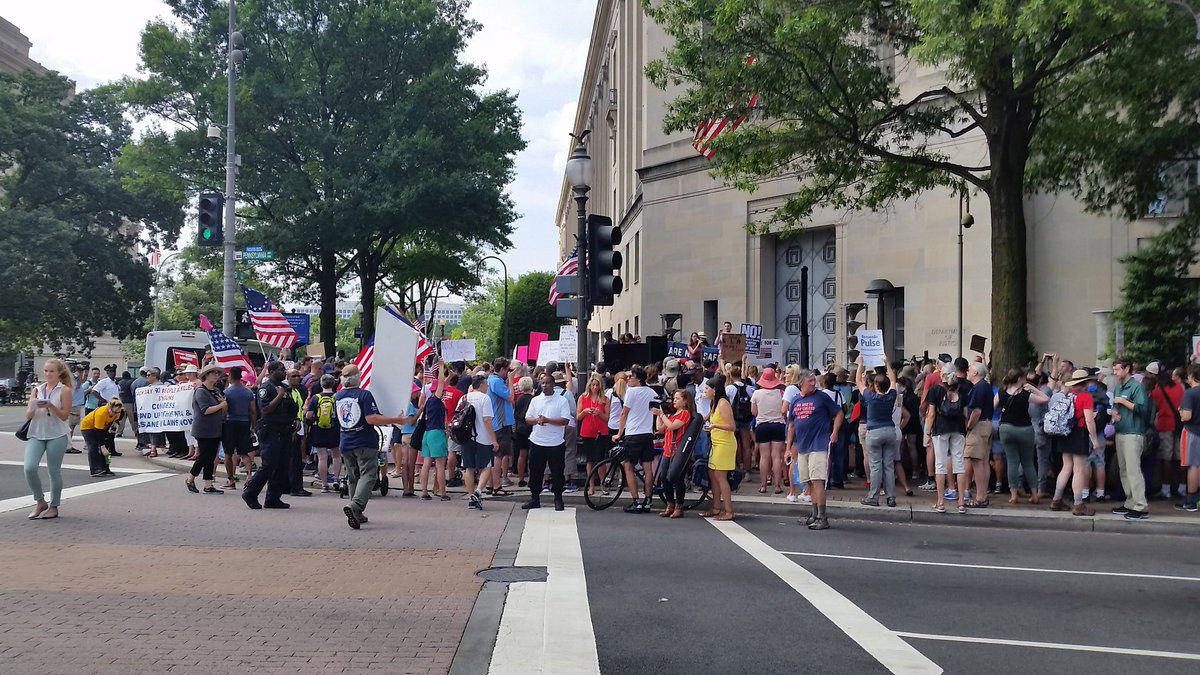 Hundreds of protesters gathered outside of the Department of Justice on Saturday in the second day of a protest against the NRA. (WTOP/Kathy Stewart)