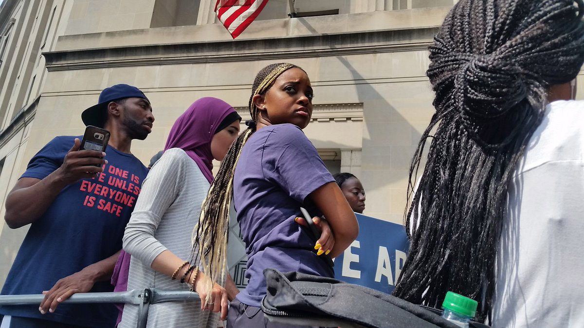 Tamika Mallory, co-president of the Women's March (center), called on the NRA to remove what is being called a controversial video. (WTOP/Kathy Stewart)