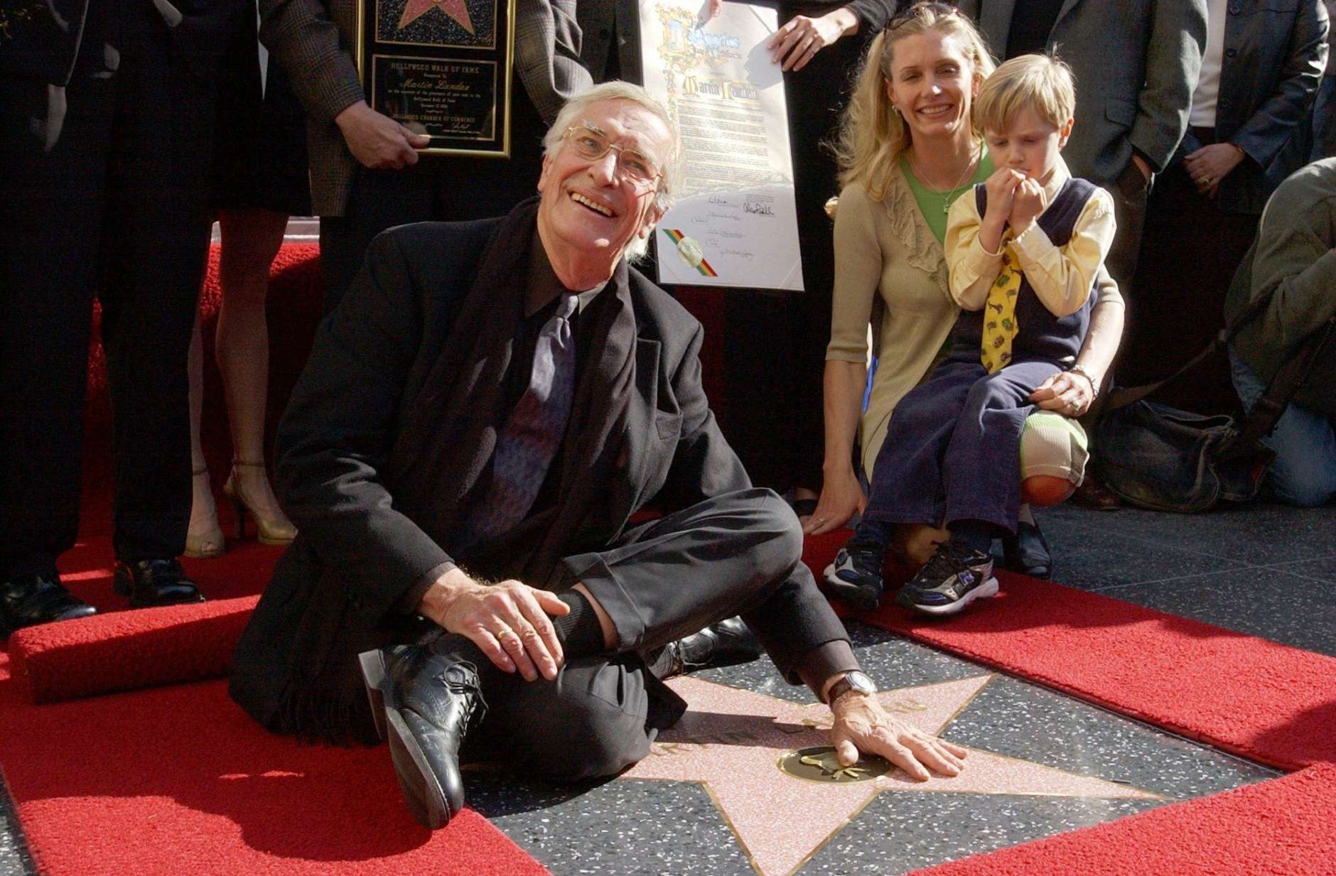 Actor Martin Landau, left, poses for photographers on his star on the Hollywood Walk of Fame, Monday, Dec. 17, 2001, in Los Angeles. Landau, who was honored with the 2,187th star on the wold famous walk, has had an acting career spanning more than four decades in nearly 90 films. Pictured to Landau's right are friend Gretchen Becker and Landau's godson Dylan Becker. (AP Photo/Rene Macura)