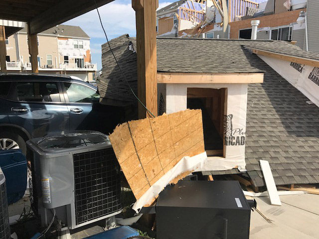 Port of a roof crushes a car at a condo complex in Stevensville, Maryland, on July 24, 2017. The National Weather Service confirmed that rare, strong tornado hit the Kent Island community early Monday morning. (WTOP/Steve Dresner)
