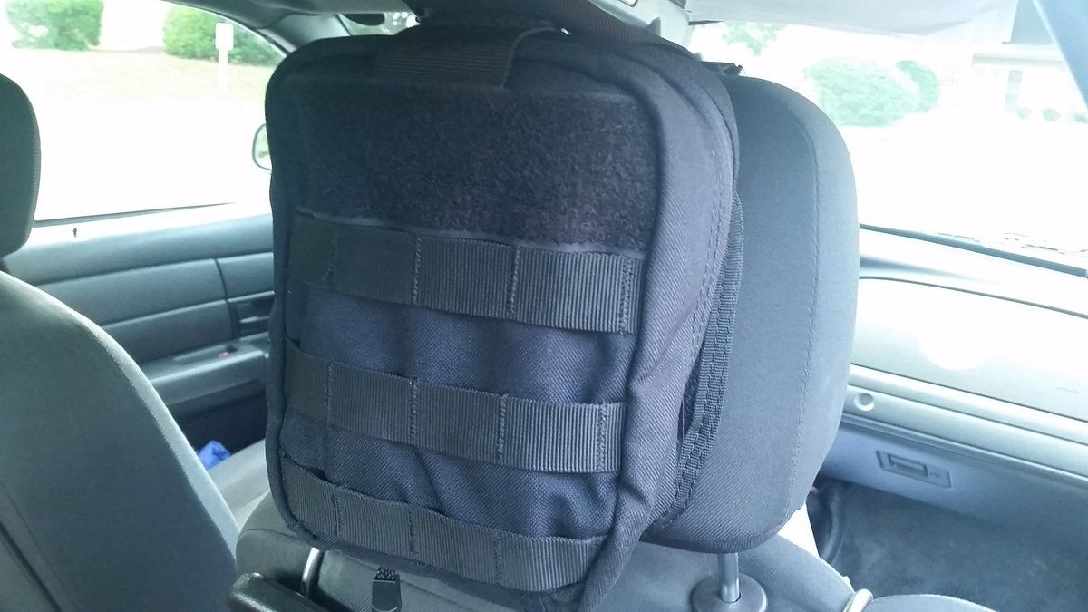 These nondescript black packs attached to the back of the passenger seat headrest in police cruisers have been powerful when it comes to saving lives in an emergency. (WTOP/Kathy Stewart)