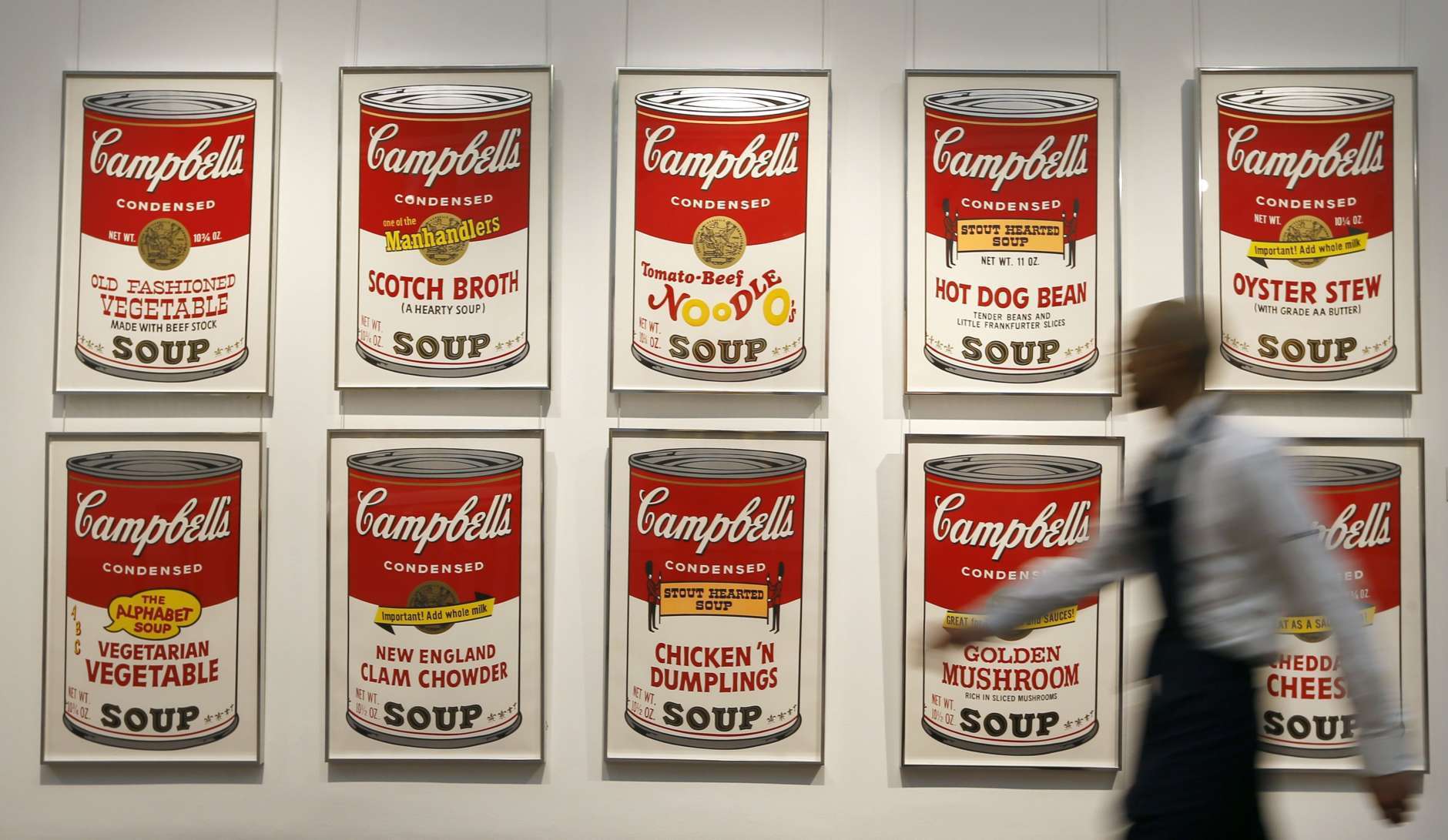 A Sotheby's technician walks past a set of Andy Warhol's Campbell's Soup screenprints at the auction rooms in London, Friday, March 15, 2013. The set of ten screenprints is estimated at 100,000-150,000 pounds ($152,000-228,000) (euro 116,000-174,000) and will go for auction on March 19, in London. (AP Photo/Kirsty Wigglesworth)