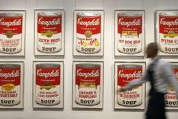 A Sotheby's technician walks past a set of Andy Warhol's Campbell's Soup screenprints at the auction rooms in London, Friday, March 15, 2013. The set of ten screenprints is estimated at 100,000-150,000 pounds ($152,000-228,000) (euro 116,000-174,000) and will go for auction on March 19, in London. (AP Photo/Kirsty Wigglesworth)