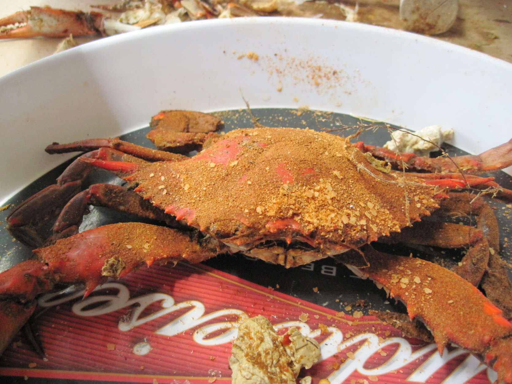 Photo shows a single steamed crab on a tray.